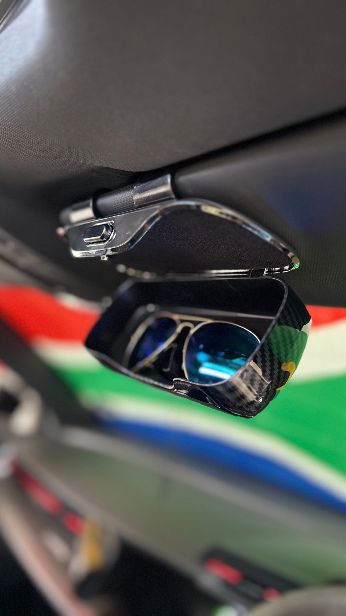 The Car Edit Carbon Case sunglasses holder with carbon-fibre finish for a car sun visor