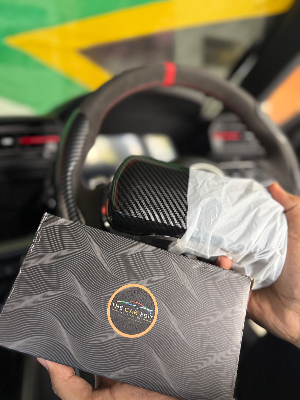 The Car Edit Carbon Case sunglasses holder with carbon-fibre finish for a car sun visor