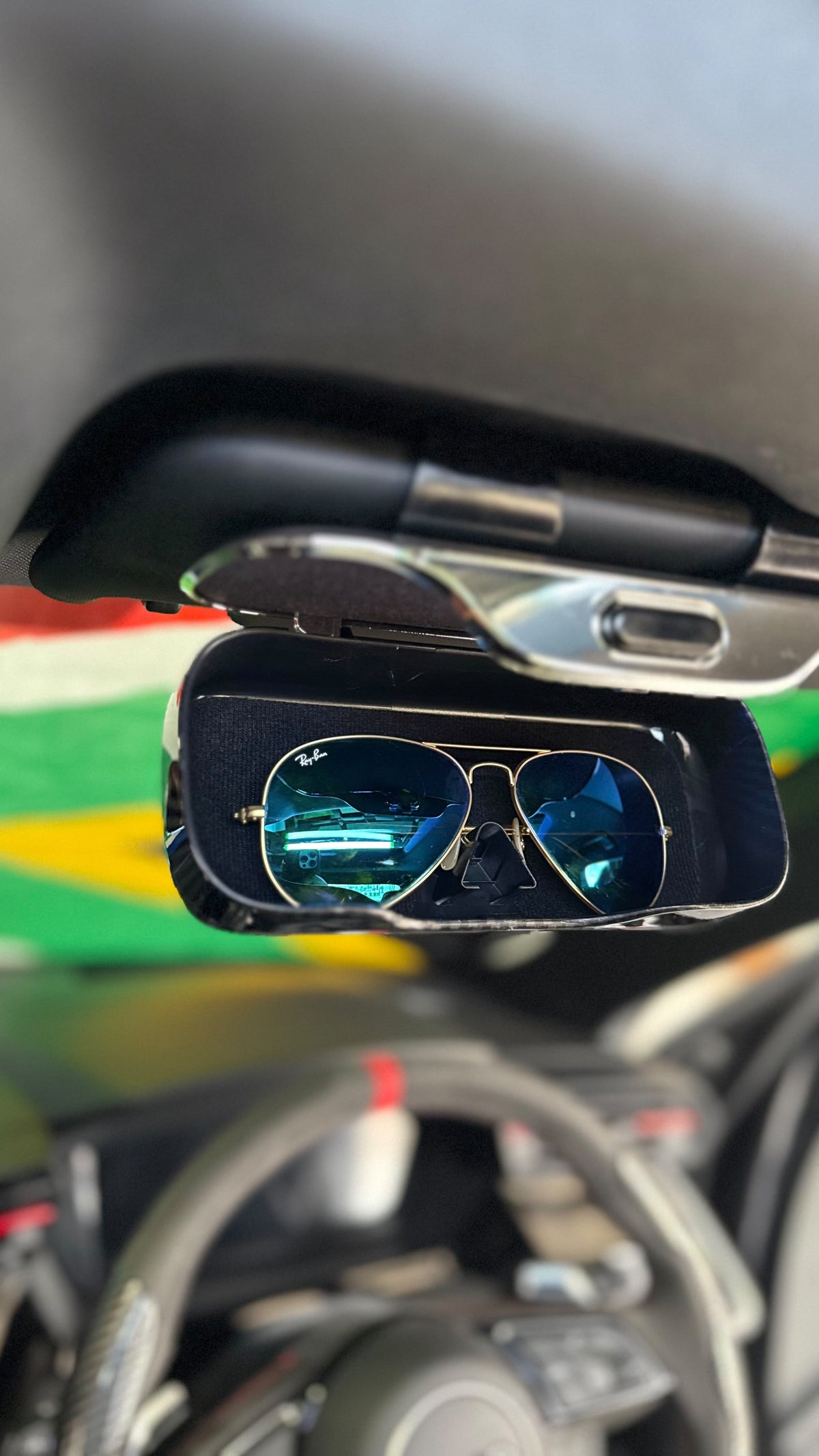 The Car Edit Carbon Case sunglasses holder with carbon-fibre finish for a car sun visor