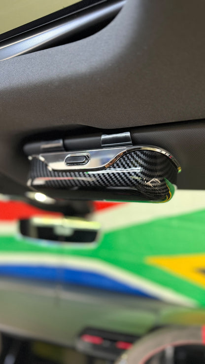 The Car Edit Carbon Case sunglasses holder with carbon-fibre finish for a car sun visor