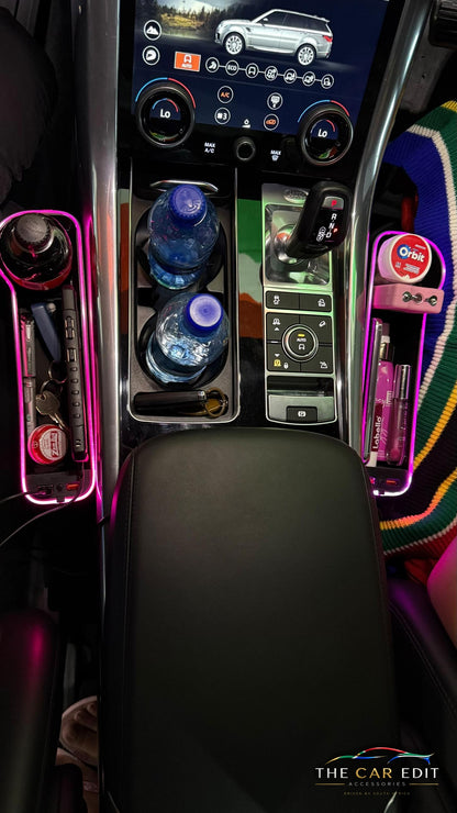 The Gap Keeper Pro pair glowing pink, holding a drink, keys, power bank and lip balm