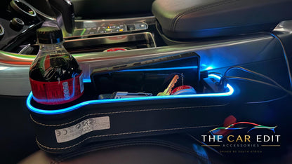 The Gap Keeper Pro lit pink with dual USB ports, holding everyday essentials