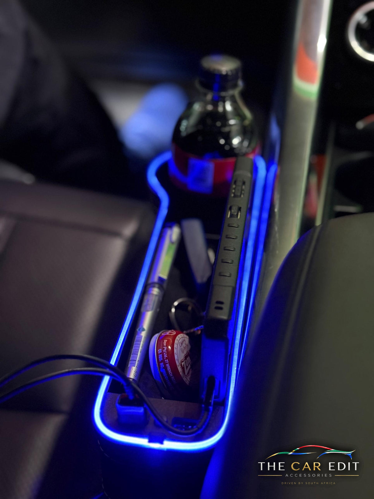 Close-up of The Gap Keeper Pro with blue LED glow, cup holder and storage