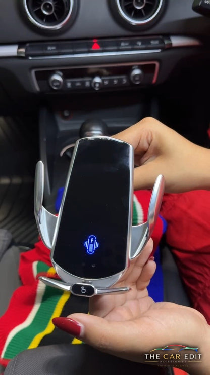 GripBot wireless charging mount in silver held in hand, arms open