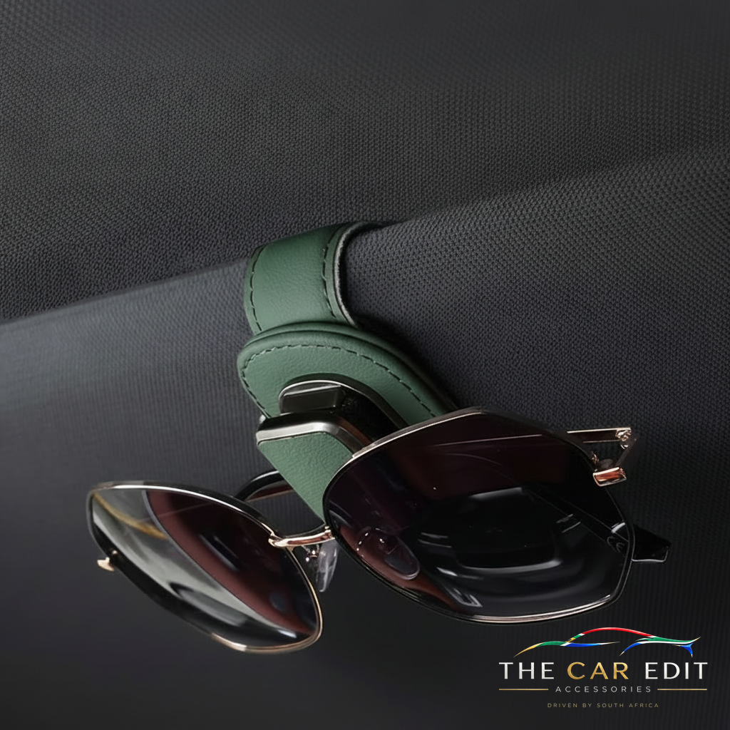 Green leather Visor Clip holding sunglasses on a car sun visor