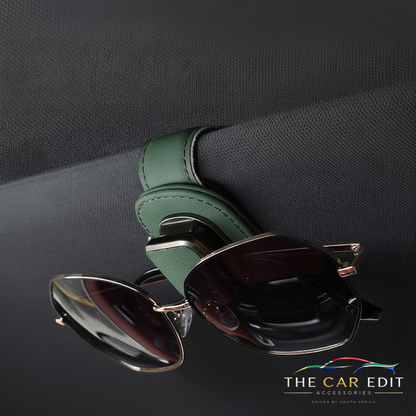 Green leather Visor Clip holding sunglasses on a car sun visor