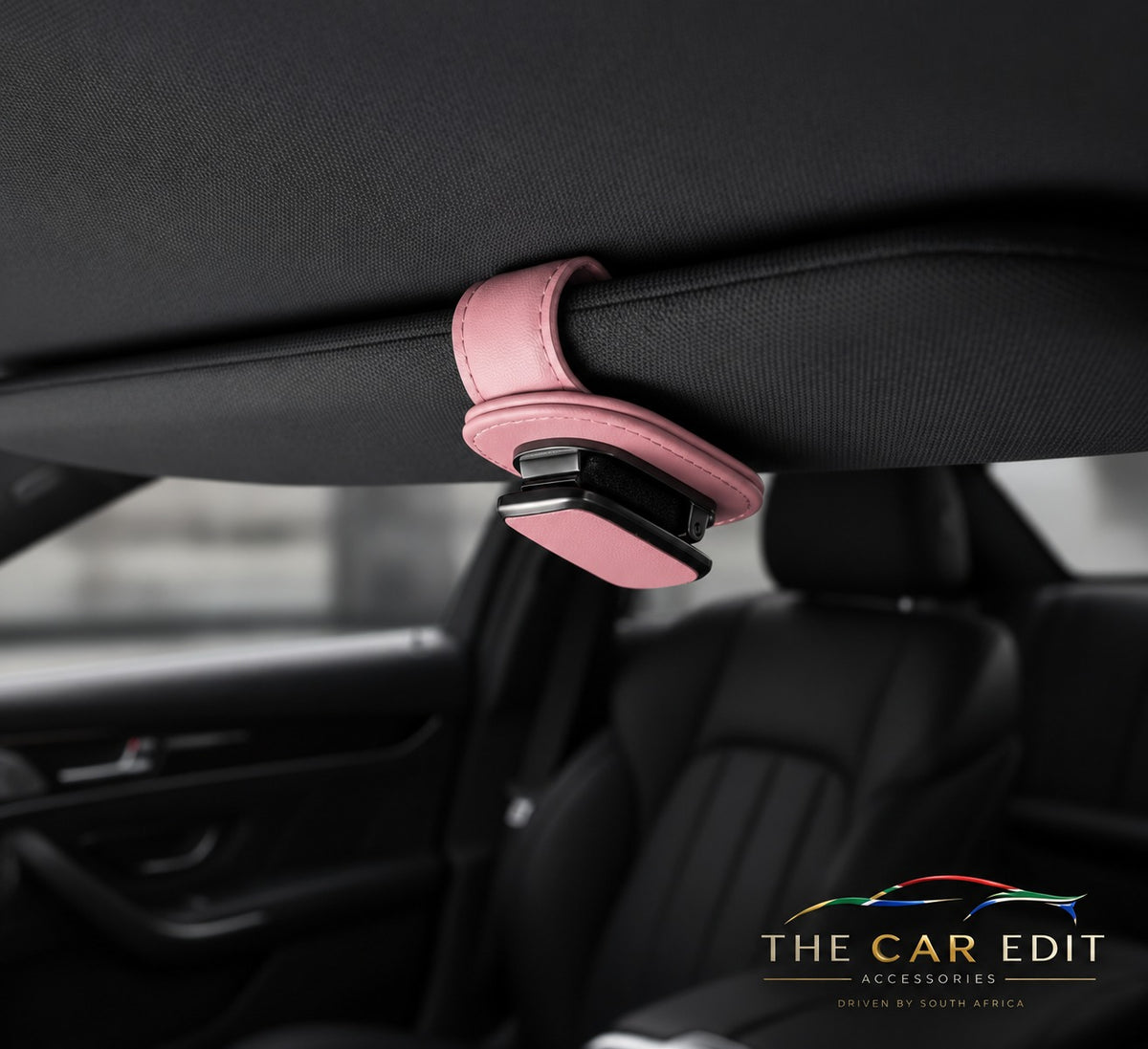 The Visor Clip in Pink leather fitted to a car sun visor