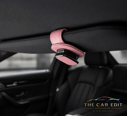 The Visor Clip in Pink leather fitted to a car sun visor
